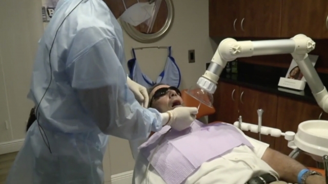 Dentist works on a patient.