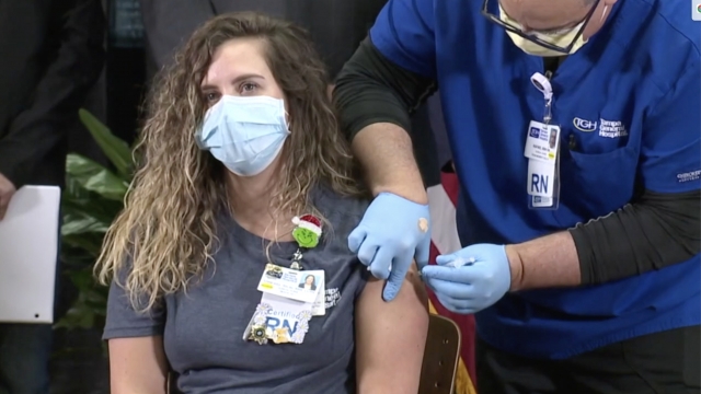 Health care worker gets vaccine shot