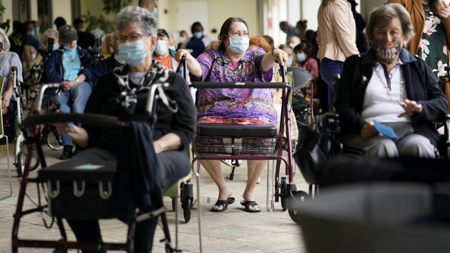 Residents of Thee Palace assisted living facility in Coral Gables, Fla. Florida wait after receiving the COVID vaccine.