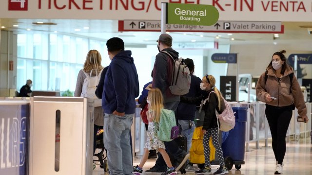 Air travelers process through a security check point at Love Field Airport in Dallas.