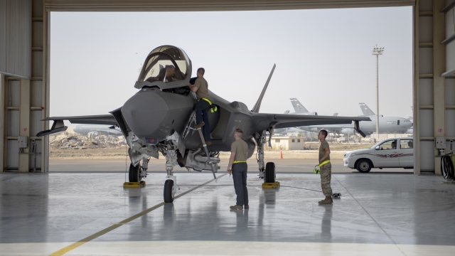 An F-35 fighter jet pilot and crew prepare for a mission at Al-Dhafra Air Base in the United Arab Emirates.