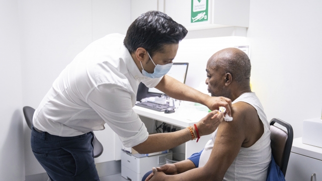 A pharmacist administers a dose of the Oxford/AstraZeneca covid vaccine