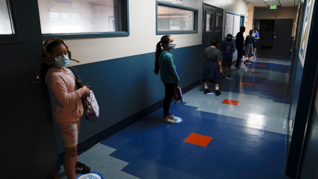 Los Angeles Unified School District students stand in a hallway socially distance during a lunch break at Boys & Girls Club