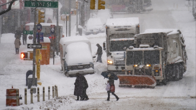 Pedestrians walk in snow storm