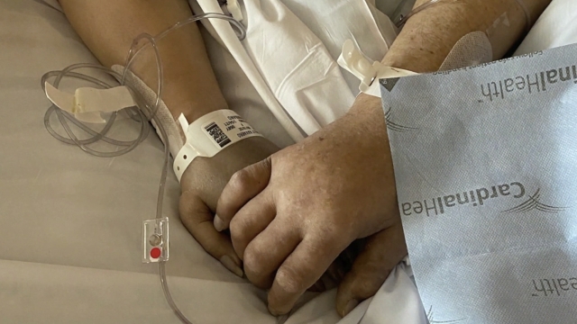 Couple holds hands in the hospital