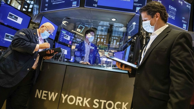 A specialist works with traders on the floor of the New York Stock Exchange