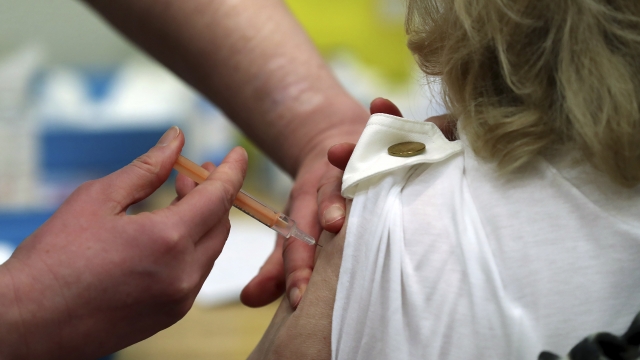 Someone receives an injection of the Oxford/AstraZeneca vaccine at a mass vaccination centre