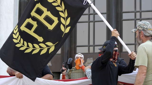 A protester carries a Proud Boys banner.