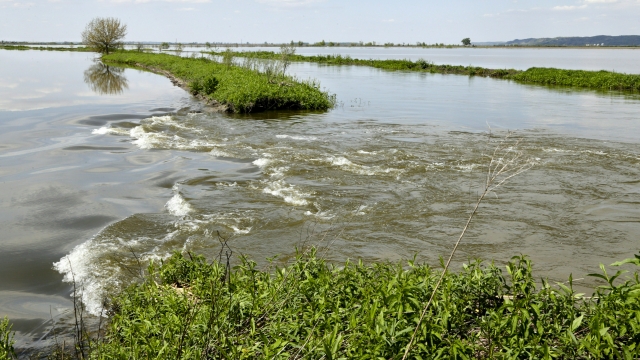 Floodwaters from the Missouri River flow through a break in a levee, north of Hamburg, Iowa, on May 10, 2019.