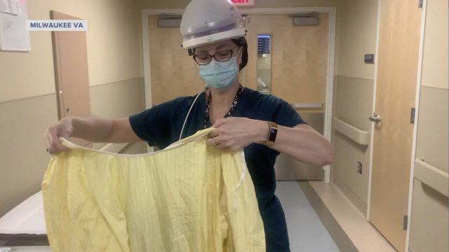 Nurse puts on PPE