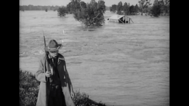 A U.S. Army officer patrols near floodwaters in 1927