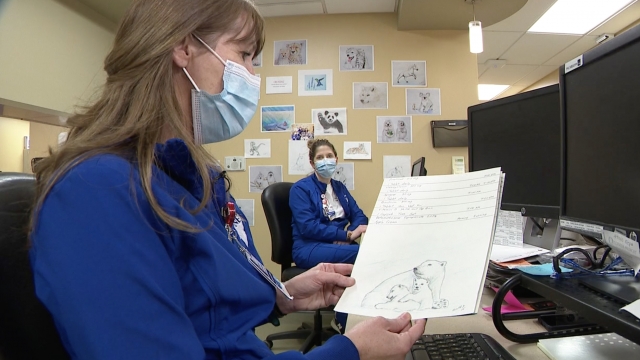 Nurse holds a sketch.