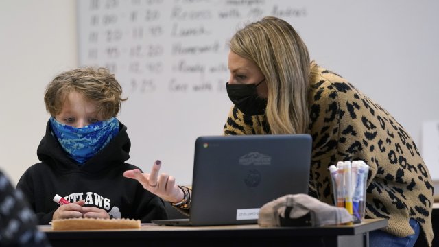 Teacher and student wearing masks