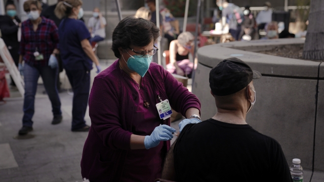 A registered nurse administers the COVID-19 vaccine