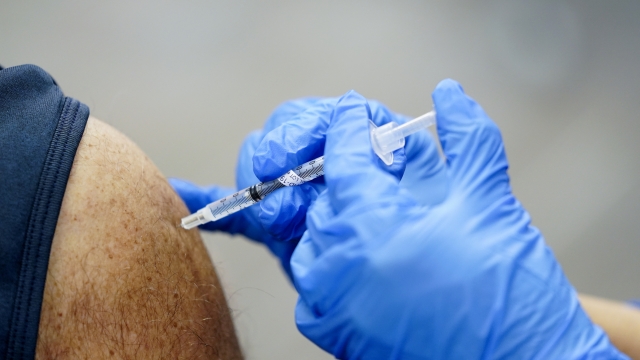 A healthcare worker receives a second Pfizer-BioNTech COVID-19 vaccine shot.