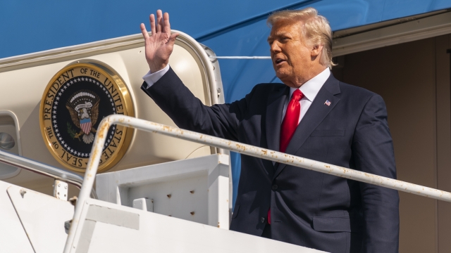 Former President Donald Trump waves as he disembarks from his final flight on Air Force One.