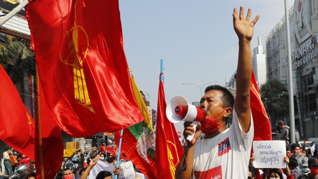 A man uses a loudspeaker to address a crowd of protesters in Mandalay, Myanmar