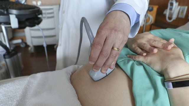 A doctor performs an ultrasound scan on a pregnant woman at a hospital in Chicago