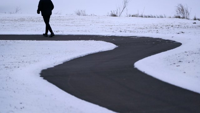 Kansas man runs on a cold, snowy path