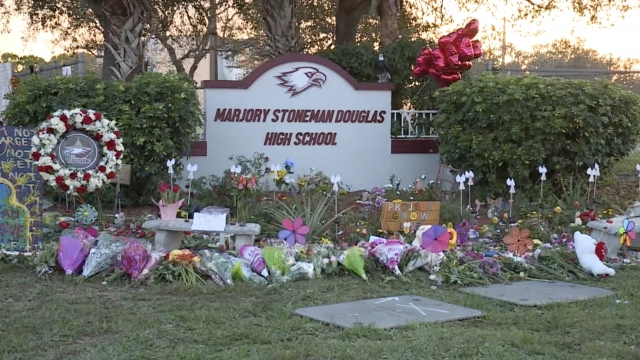 A memorial grows outside a high school.