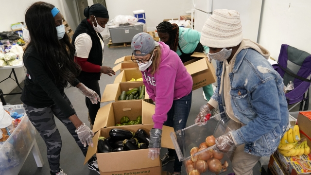 Volunteers organize food for distribution.