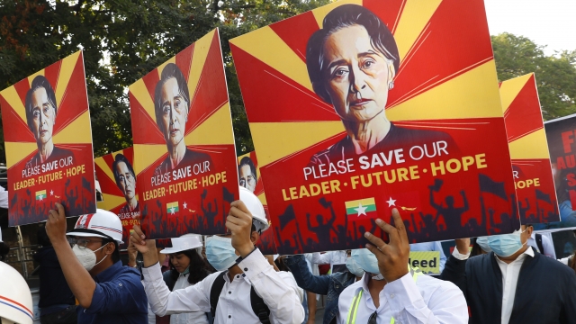 Engineers hold posters with an image of deposed Myanmar leader Aung San Suu Kyi