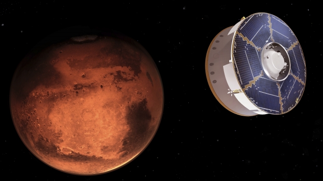 This illustration provided by NASA depicts the Mars 2020 spacecraft carrying the Perseverance rover as it approaches Mars