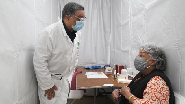 New York: Dr. Victor Peralta talks with a patient before giving her the second dose of the COVID-19 vaccine.