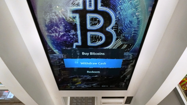 Bitcoin logo on the screen of a cryptocurrency ATM.