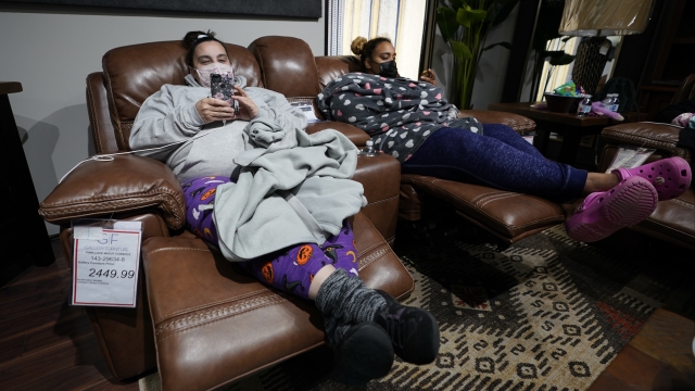 Sherry Brown, left, and her daughter, Taylor, rest in recliners at Gallery Furniture store after the store owner opened up fo