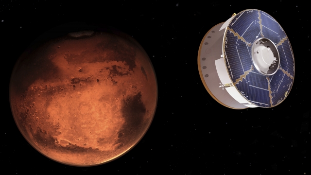This illustration provided by NASA depicts the Mars 2020 spacecraft carrying the Perseverance rover as it approaches Mars