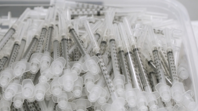 Syringes sit in a box.