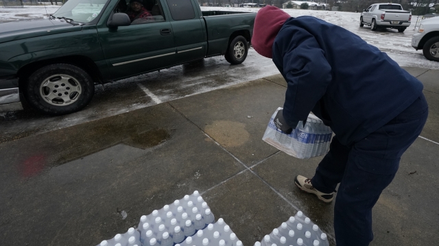 Bottled water is handed to residents of Jackson, Miss.