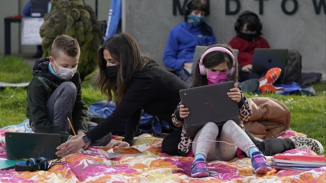 students and parents attend distance learning Zoom classes at Midtown Terrace Playground in San Francisco,