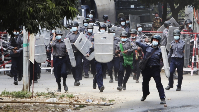 Police charge forward to disperse protesters in Mandalay, Myanmar on February 20.