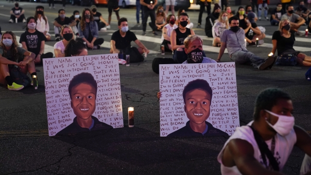 Posters showing images depicting Elijah McClain during a candlelight vigil in Los Angeles, California