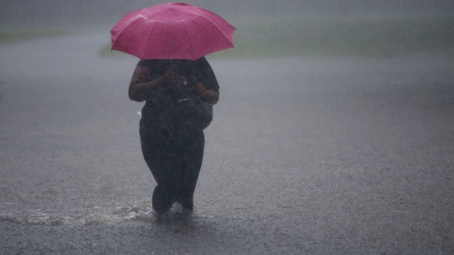 Woman walks through flooded water in Philadelphia