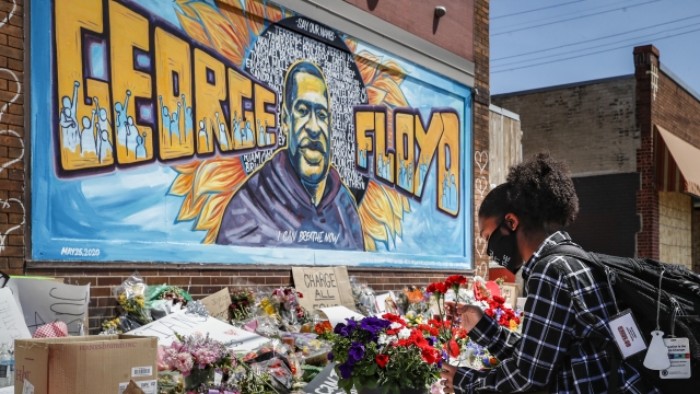 Flowers at a memorial mural for George Floyd
