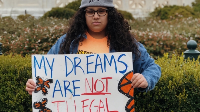 Undocumented immigrant Andrea Anaya hols a sign saying "my dreams are not illegal"