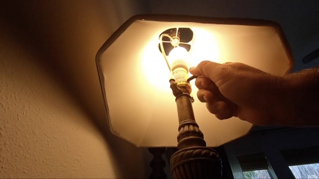 Man turns off a lamp.