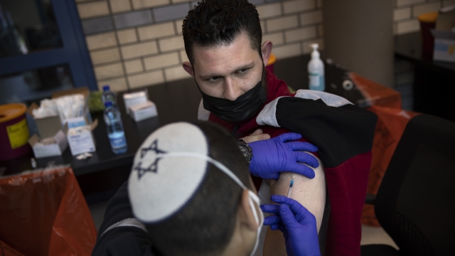 Israeli medical teams administer the Pfizer-BioNTech COVID-19 vaccine