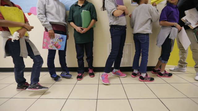 Migrant teens line up for a class at a "tender-age" facility for babies, children and teens, in Texas' Rio Grande Valley