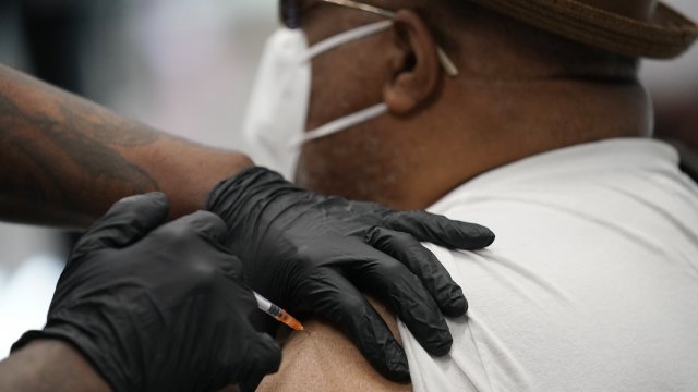a man receives a COVID-19 vaccine at the Martin Luther King Senior Center in North Las Vegas.