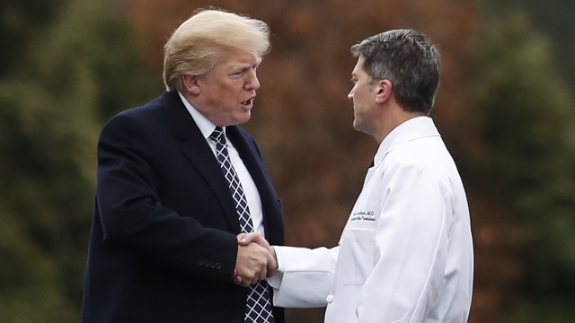 President Donald Trump shakes hands with White House physician Dr. Ronny Jackson