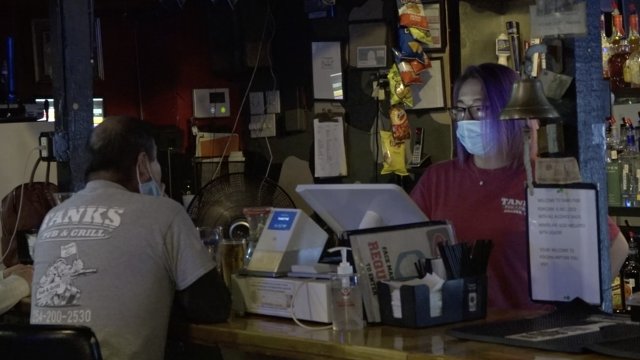 Woman works at a bar.