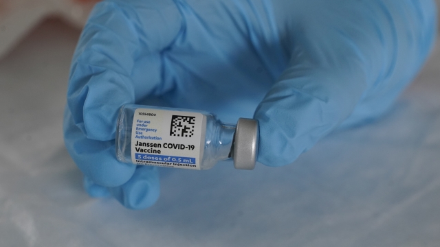 A person holds a vial of the Johnson & Johnson COVID-19 vaccine.