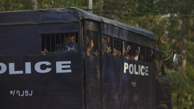 police transport vehicle is driven with detainees, believed to be student protesters.