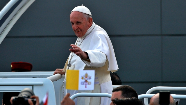 Pope Francis waves to faithful as he arrives for an open air Mass at a stadium in Irbil, Iraq.