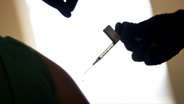 a droplet falls from a syringe after a health care worker is injected with the Pfizer-BioNTech COVID-19 vaccine