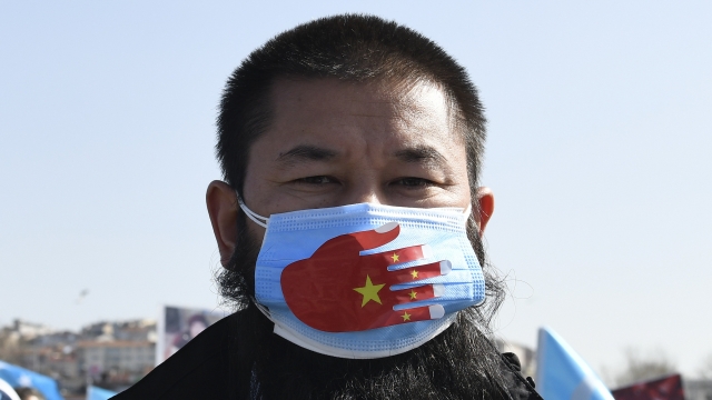 A member of the Uyghur community living in Turkey, joins a protest against China